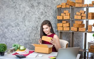 A small business owner packaging products for online sales, representing e-commerce sellers preparing for new U.S. import rules after the de-minimis policy ends in 2025.