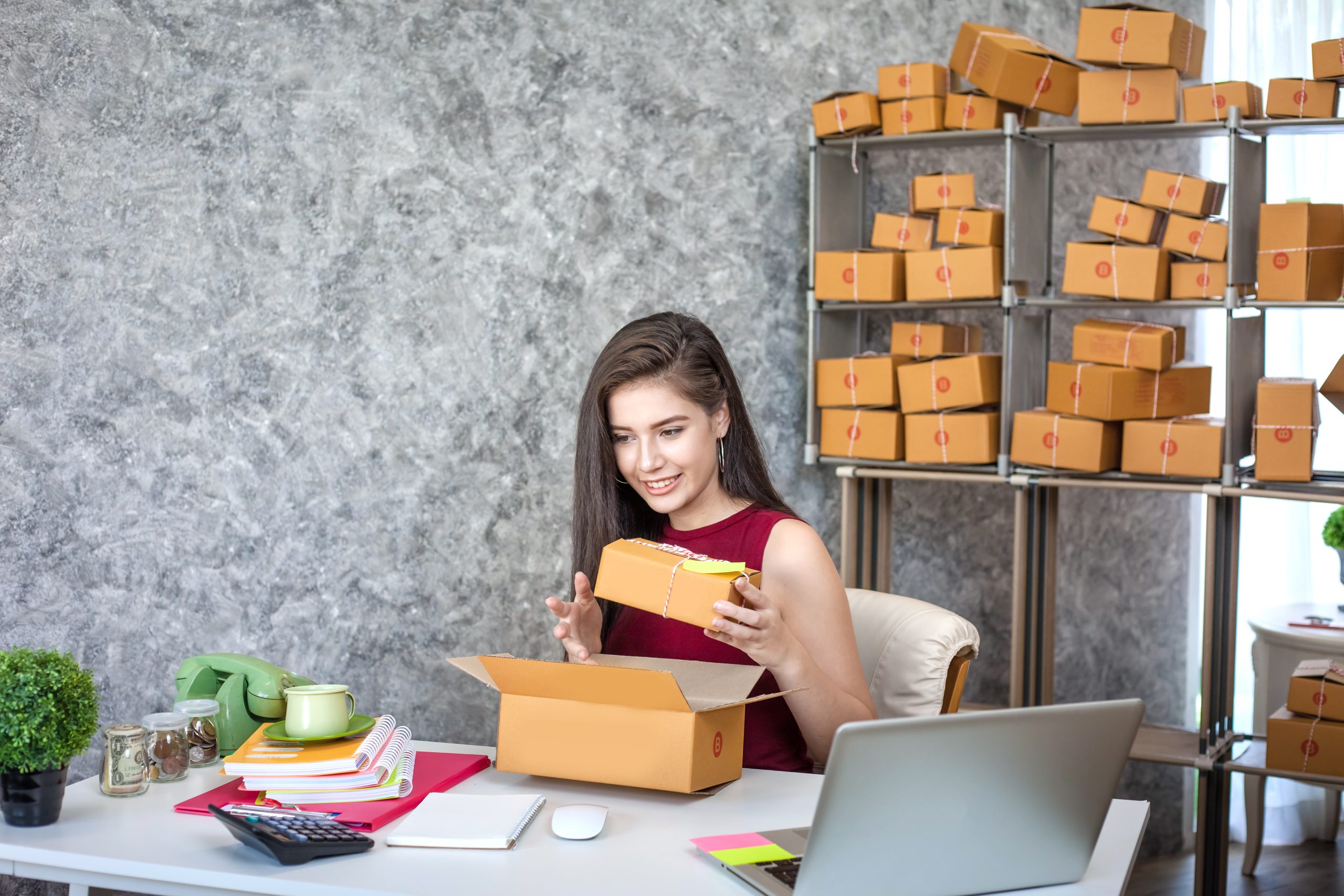 A small business owner packaging products for online sales, representing e-commerce sellers preparing for new U.S. import rules after the de-minimis policy ends in 2025.