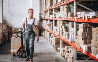 Warehouse worker pulling a pallet jack